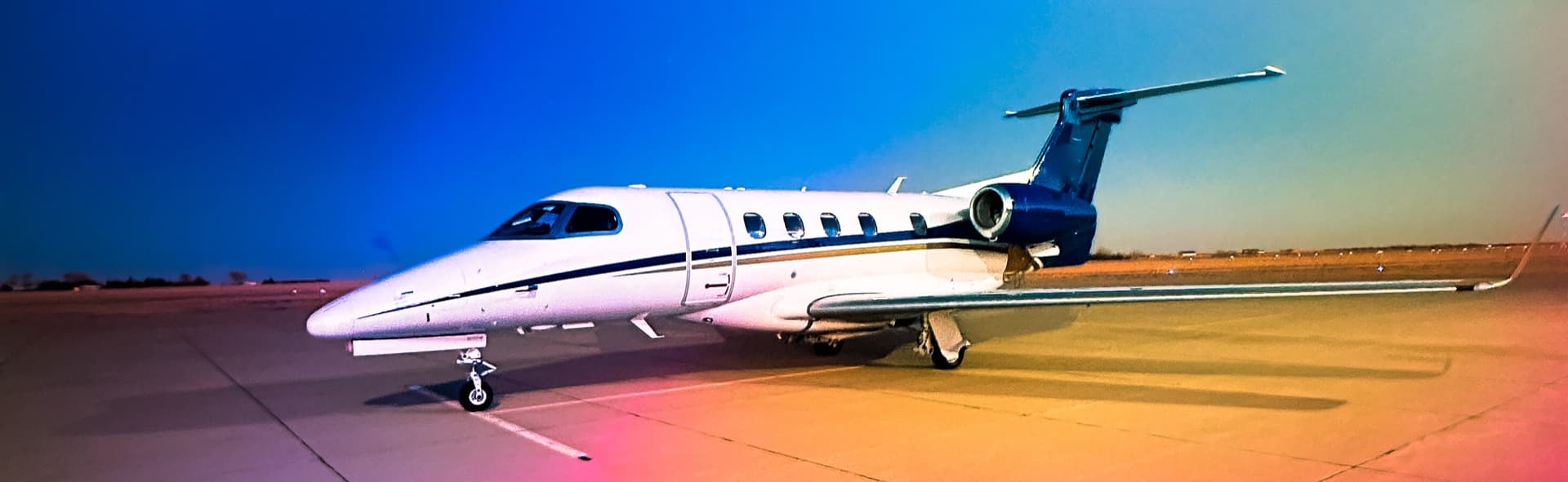 Embraer Phenom 300 on the ramp at twilight