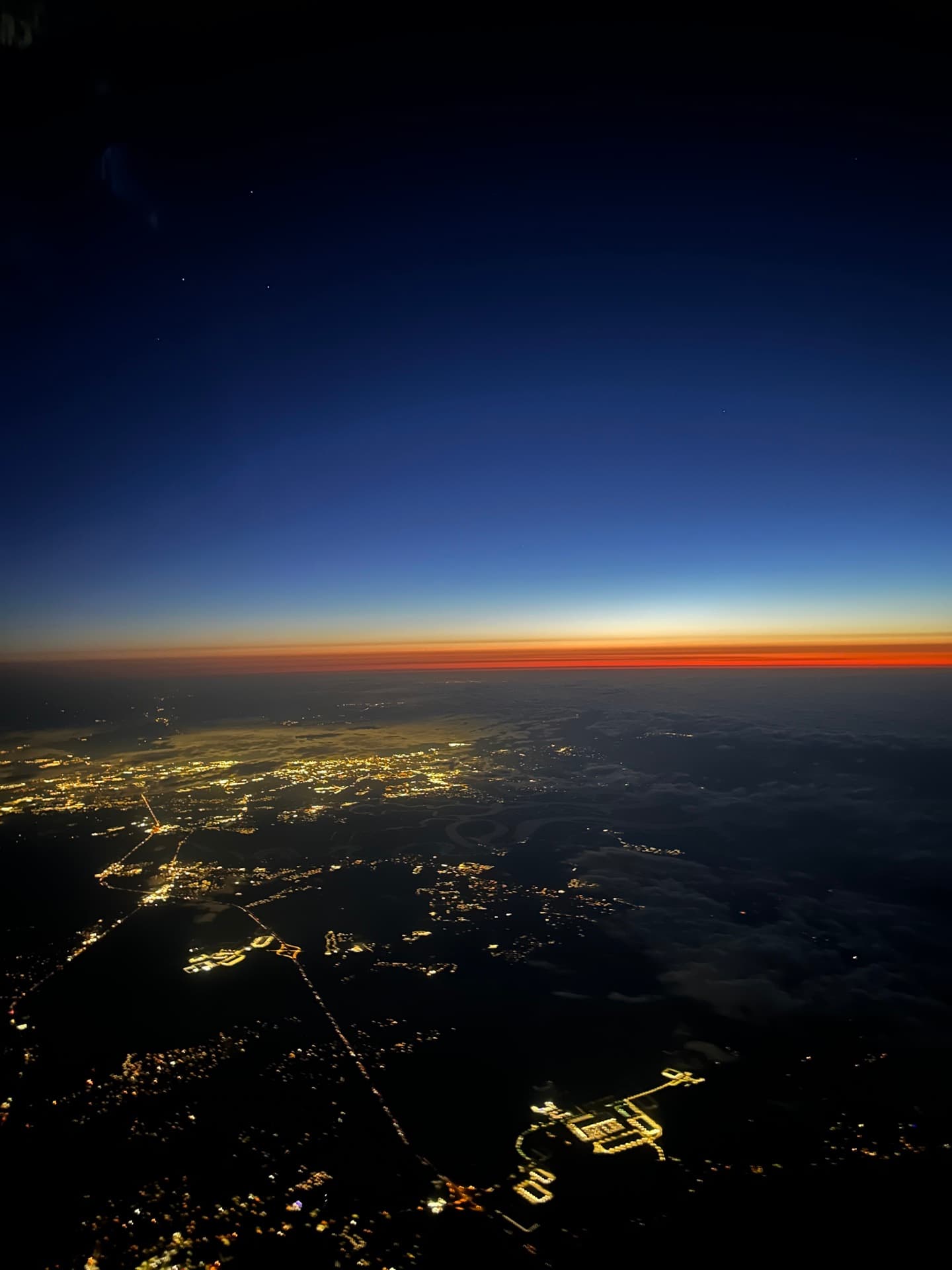 Sunset horizon from the Phenom 300 at altitude